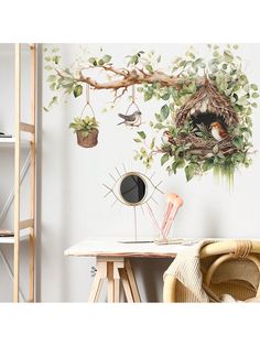 a bird's nest is hanging on the wall next to a table