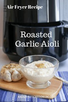 an air fryer is shown with garlic in front of it and the words roasted garlic aioli