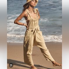 The Perfect Throw-On-And-Go Look From Our Free-Est Collection, Featuring A Cinch Neckline With Tie Detailing And Slouchy, Wide-Leg Harem Silhouette. Waist-Tie Detail Dropped Side Pockets Dropped Armholes Free-Est Comprised Of Textured, Free-Flowing Wardrobe Staples, Free-Est Takes Our Most-Loved Beach And Summer Collections And Unites Them For Every Day And Any Wear. Care/Import Machine Wash Cold Gentle Import Measurements For Size L Hips: 64” Bust: 54.5” Waist: 33.4” Relaxed Rise: 28” Inseam: 1 Tie Waist Jumpsuit, Free People Pants, Ivory Color, Waist Tie, Wardrobe Staples, Jumpsuits For Women, Pant Jumpsuit, Jumpsuit Romper, Free People