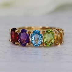 Rainbow Gemstone Ring, Amethyst Garnet Citrine Blue Topaz & Peridot Half Eternity Band Ring, Natural Rainbow Gemstone Ring, Rainbow Ring  ------------------------------------------------------------------------------------------------------------------------------------------------------------------------------------------------------------- ◈ Item Details ◈ Metal : Sterling Silver Metal Purity: 925 Parts Per 1000 Style : Vintage Ring Main Stone : Natural Amethyst Garnet Citrine Blue Topaz & Perido Stone Size : 5x7 mm Stone Shape : Oval Stone Wight : 3.40 Ct Approx.  Silver Weight : 3.20 Gram Other Stone : CZ Diamond Occasion : Party , Anniversary , Wedding, Birthday , Engagement 925 sterling silver with silver/white/yellow/rose gold plated. Sent in a very elegant wedding ring box, ready f Luxury Multi-stone Birthstone Ring With Round Cut, Luxury Multicolor Round Topaz Ring, Elegant Wedding Rings, Precious Stones Rings, Rainbow Rings, Rainbow Gemstones, Kahlil Gibran, Wedding Ring Box, Eternity Band Ring