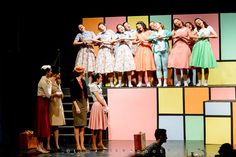 a group of people standing on top of a stage