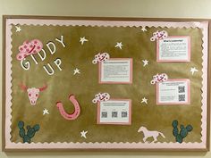 a bulletin board is decorated with pink and white paper, cowboy themed items, and words