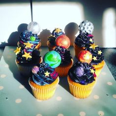 cupcakes decorated with different types of decorations on top of a polka dot table