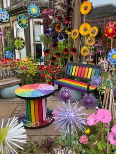 a bench sitting in the middle of a garden filled with lots of flowers and plants