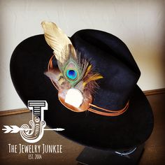 If you’re looking for the perfect accessory to complement your favorite boho style, look no further. This Boho-Style Western Felt Hat w/ Natural Feather & Turquoise Hat Accent by The Jewelry Junkie is absolutely everything that you need. Not only is it easy to incorporate into any and all outfits, but the genuine leather and natural feathers of the band immediately elevate whatever it is you’re wearing. One Size Hat with adjustable inner hat liner (see last photos) The same primary feathers will Black Bohemian Felt Hat For Western-themed Events, Black Bohemian Felt Hat For Kentucky Derby, Adjustable Felt Hat With Feathers For Festivals, Bohemian Adjustable Hat Band With Feathers, Unique Adjustable Fedora For Festival, Artisan Hats With Feathers And Adjustable Fit, Handmade Bohemian Hat Bands For Kentucky Derby, Unique Adjustable Hat For Festivals, Handmade Bohemian Costume Hats With Flat Brim