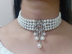 Elevate your style with our Pearl Elegance Choker Set, meticulously crafted in silver and adorned with unique 5A lab-created diamonds by CZ. These luxurious stones create a vivid and high-quality appearance, giving the jewelry a real diamond feel. Finished with 18kt gold accents and a highly-reflective rhodium polish, this set is not only stunning but also durable, ensuring it stays radiant for years to come. Finish: White Gold Plating Material: Silver, Alloy, CZ Stones, Pearls Color: White Size: One Size Closure Type: Hook and Links Box Contains: 1 Necklace and 1 Pair Earrings Luxury Bling Jewelry For Wedding, White Pearl Jewelry With Rhinestones, Luxury White Jewelry With Rhinestones, Classic Diamond White Jewelry For Party, Glamorous White Jewelry With Elegant Design, White Sparkling Pearl Jewelry, Diamond White Classic Jewelry With Crystals, Luxury White Rhinestone Jewelry, Glamorous White Jewelry With Sparkling Stones