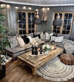 a living room filled with lots of furniture and decor on top of a wooden floor