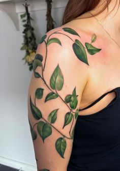 a woman with green leaves on her arm