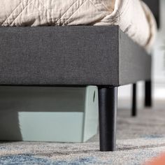 a bed sitting on top of a carpet covered floor