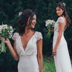 two beautiful women in white dresses holding flowers