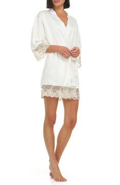 A lustrous satin robe edged with sheer floral lace is sure to make your mornings and evenings a little bit sweeter. 35 1/2" length (size Medium) Shawl collar Three-quarter sleeves Removable tie belt 100% polyester Hand wash, dry flat Imported Fitted Lace Robe For Wedding Night, Cream Wedding Robe For Spring, Feminine Lace Robe For Wedding Night, Fitted Robe With Lace Sleeves For Wedding Night, Fitted Lace Robe With Sheer Details, Fitted Lace Robe With Lace Trim, Fitted Sheer Lace Robe, Fitted Wedding Night Robe With Lace Sleeves, Elegant Summer Robe With Lace Trim