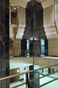 the interior of a building with marble walls and floors, as well as metal railings