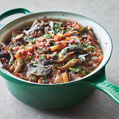 a green pot filled with food on top of a table