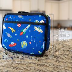 100% play-proof and perfect for elementary school age, Wildkin's classic square shaped lunch box is designed to help you and the environment by offering a fun and reusable option for lunch and snack time. Apart from the roomy main compartment, this lunch box features a zippered front pocket that is perfect for hiding a surprise treat or securing sweet notes. The lunch box also features an interior mesh pocket for storing napkins, utensils or an ice pack. Sized just right for kids and adults, the Portable Lunch Box For Travel And Back To School, Portable Rectangular Lunch Bag For Back To School, Rectangular Portable Lunch Bag For Back To School, Functional Rectangular Lunch Bag For Back To School, Functional Multicolor Lunch Box For School, Functional Multicolor School Lunch Box, Blue Rectangular School Case, Portable Blue Lunch Box, Blue Portable Lunch Box