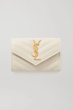 SAINT LAURENT's wallet has been made in Italy from leather that's pebbled and quilted to ensure it stays flawless for longer. Detailed with a gold plaque at the front flap, it's fitted with a back slip pocket and two within its central internal compartment.Wear it with: [SAINT LAURENT Skirt id1265039], [SAINT LAURENT Sweater id1265063]. Cute Designer Wallets, Wallets For Women Designer, Random Belongings, Expensive Wallet, Designer Makeup Bags, Pretty Wallet, Designer Wallets For Women, Styling Lookbook, Saint Laurent Sweater