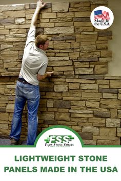 a man that is standing up against a wall with some kind of rock on it