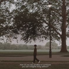 a man walking down a sidewalk next to a tree and lamp post with the words how do you say goodbye to someone?