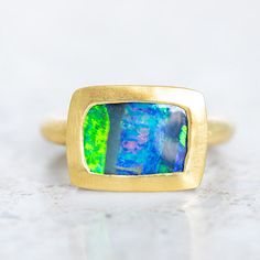 This rectangular boulder opal from Queensland is set into 18ct Yellow Gold. Rectangle Boulder Opal 4.30ct. Gold weight 11.8g approx. This ring is a size N in 18ct yellow gold with a matte finish. Please give us a call if you need this re-sized, we can take it up/down 2 sizes. If you would like this ring up/down beyond the 2 sizes, there is a $480 remake fee. Luxury Gold Opal Ring Hallmarked, Yellow Gold 14k Multi-stone Opal Ring, Vintage Multi-stone 14k Gold Opal Ring, Luxury Gold Multi-stone Opal Ring, 14k Gold Multi-stone Opal Ring, Boulder Opal Ring, Gold N, Boulder Opal, Opal Rings