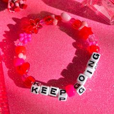 a bracelet for reminding you to keep going! 💕 details ❥ approximately 6.5 inches & super stretchy 🐛 ❥ can be adjusted to your sizing :) 🌈 ❥ want this same design but want it to say something else? i can do that ☎️ Kandi Bracelet Ideas, Bracelets Kandi, Bracelet Y2k, Kawaii Bracelet, Kandi Inspo, Diy Kandi Bracelets, Scene Goth, Diy Kandi, Candy Bracelet