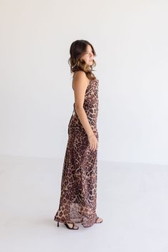 Get ready to pounce on style in the Rebecca Midi Dress. With its playful leopard print and sassy sleeveless design, this dress is perfect for date night. Don't forget the cowl neckline with back tie closure for an extra touch of charm. Style with strappy heels and a clutch. Details + Fit 100% Polyester Runs True to Size Hand Wash Cold Hang Dry Cowl Neckline Sleeveless Adjustable Shoulder Straps Back Tie Closure Side Zipper Closure Lined Leopard Print Design Brown | Multi | Printed Model is 5'2" Chic Leopard Print Dresses For Night Out, Chic Leopard Print Maxi Dress For Date Night, Chic Leopard Print Maxi Dress, Leopard Print Midi Dress For Brunch, Summer Leopard Print Dress For Date Night, Sleeveless Leopard Print Beach Dresses, Sleeveless Leopard Print Evening Dress, Sleeveless Leopard Print Party Dress, Chic Sleeveless Leopard Print Dress