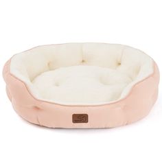 a dog bed with a pink and white color scheme