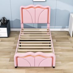 a pink bed with wooden headboard and foot board