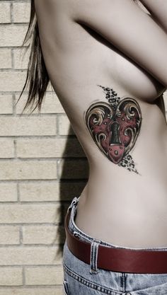 a woman with a heart tattoo on her stomach