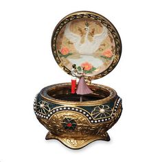 an ornate box with a figurine in it