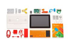 an assortment of electronics including a tablet, keyboard, mouse and other items laid out on a white surface