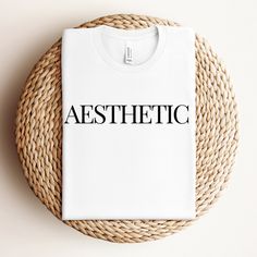 Trendy Aesthetic Women's T-Shirt, designed for those who embrace simplicity and elegance in their style. This chic tee is the perfect blend of comfort and fashion, making it a must-have for any trendsetter. Chic Summer T-shirt With Letter Print, Chic Summer Streetwear T-shirt, Aesthetic Letter Print T-shirt With Crew Neck, Chic Relaxed Fit T-shirt With Crew Neck, Chic Relaxed Fit Crew Neck T-shirt, Modern Letter Print T-shirt For Spring, Chic Cotton T-shirt For Everyday, Minimalist Basic T-shirt For Summer, Aesthetic Relaxed Fit T-shirt For Summer