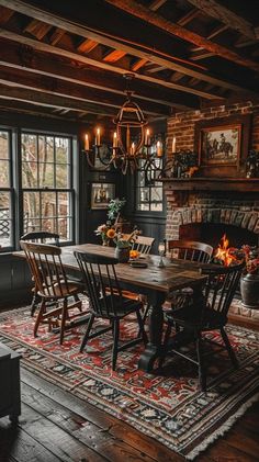 a dining room table and chairs in front of a fire place with an old fashioned fireplace