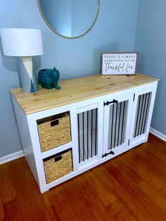 a white entertainment center with baskets on top