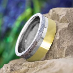 Make a timeless statement with this Mixed Metal Wedding Band. Crafted with tungsten, solid gold, and meteorite, this unique and luxurious ring is a symbol of strength and style. Enjoy a beautiful blend of classic and contemporary aesthetics with this special wedding band.RING LAYOUT Ring Width: 8 mm Ring Sleeve: Tungsten Ring Profile: Flat Ring Finish: Polished2 mm Gibeon Meteorite 2 mm Tungsten 4 mm14k Gold Mixed Metal Wedding Band, Mixed Metal Wedding, Mixed Metals Wedding, Meteorite Rings, 14k Rose Gold Jewelry, Gibeon Meteorite, Meteorite Jewelry, Metal Wedding, Mixed Metal Rings