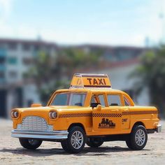 a toy taxi car with a taxi cab attached to it