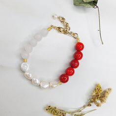 Our Vivace bracelet is a beautiful concert of color. Featuring vintage red beads, freshwater pearls, and genuine frosted quartz beads with a gold plated cable chain extension, this bracelet was handcrafted in the United States. It is a joy to wear and has a matching necklace and earring set available. Features: - Freshwater Pearls - Vintage Red Beads - Genuine Frosted Quartz - Gold Plated Cable Chain - Lobster Claw Clasp Dimensions: - Length: 8" - Extension: 2" - Total Length: 10" - Freshwater P Adjustable Red Jewelry With Pearl Charm, Red Pearl Beaded Chain Jewelry, Elegant Red Beaded Pearl Bracelet, Elegant Red Beaded Bracelet With Natural Stones, Red Pearl Bracelets With Round Beads, Elegant Red Pearl Bracelets, Hand-strung Red Pearl Beaded Bracelets As Gifts, Red Pearl Beaded Bracelets As Gift, Handmade Red Pearl Bracelet With Round Beads