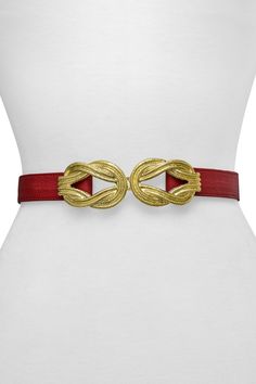 A gold-tone buckle in an eternity knot shape adds an intricate detail to a classic leather belt. Eternity knot buckle with hook closure. Leather construction. Approx. 1.25" width. Imported Chic Formal Belt Buckle With Gold-tone Hardware, Chic Formal Belt Buckles With Gold-tone Hardware, Formal Adjustable Belt With Antique Buckle, Elegant Formal Belt With Gold-tone Hardware, Chic Formal Antique Belt Buckle, Elegant Gold Leather Belt Buckles, Elegant Antique Buckle Belt For Formal Occasions, Elegant Antique Buckle Belt For Formal Events, Luxury Gold Adjustable Belt Buckle