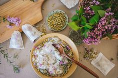 a bowl filled with food sitting on top of a table next to other bowls and spoons