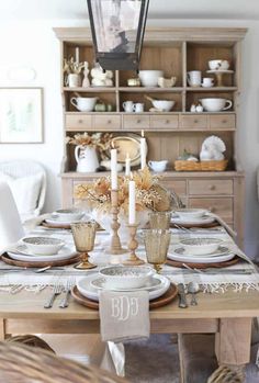 a dining room table is set with plates and silverware