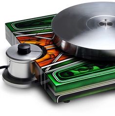 an old record player is sitting on top of stacks of cds and playing the music