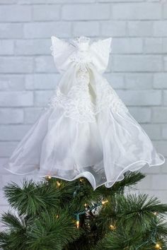 a white dress on top of a christmas tree