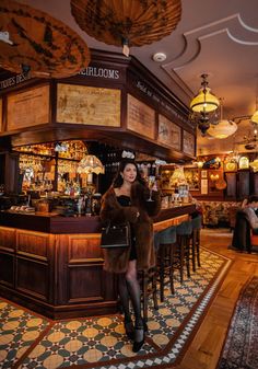 a woman standing in front of a bar