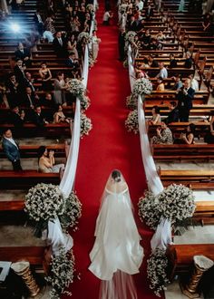 the bride is walking down the aisle in her wedding dress