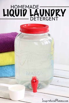 a mason jar sitting on top of a wooden table next to towels and a measuring cup