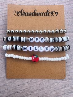 three bracelets with an apple and name on them