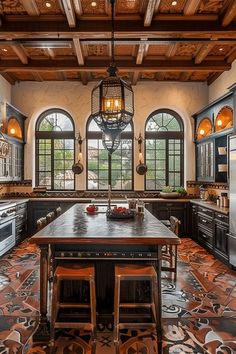 a large kitchen with an island in the middle and lots of windows on both sides