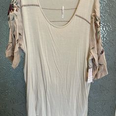 Oversized Tee With Embroidered Sleeves. Back Is Longer Than Front. Very Oversized Spring Oversized Beige T-shirt, Casual 3/4 Sleeve T-shirt For Fall, Oversized Spring Blouse With Floral Embroidery, Oversized Floral Embroidery Blouse For Spring, Oversized Floral Embroidered Blouse For Spring, Oversized Batwing Sleeve T-shirt For Spring, Beige Short Sleeve Tops For Fall, Spring Oversized Crew Neck Blouse, Oversized Crew Neck Spring Tops