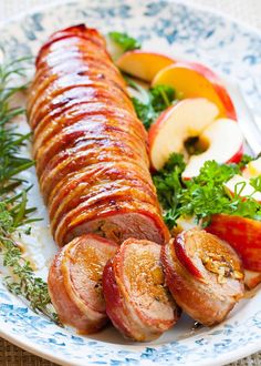 a white plate topped with sliced up meat and vegetables