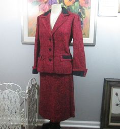 This is a vintage red and black tweed suit. From the early 60's. Label is from Salon Style Ltd., Peninsula Hotel Arcade, Lowloon, Hong Kong. The tweed appears to be a wool and silk blend. There is a black suede-like trim at the pockets, collar and cuffs. Has French cuffs. In excellent condition. Jacket fits up to a 40" bust, 34" waist and length is about 25" from top of shoulder to bottom edge. Skirt is a straight style. Zips and fastens at the side. Fits up to a 30" waist, 40" hips and length i Red Fitted Wool Suit, Fitted Red Wool Suit, Red Wool Suit For Workwear, Red Wool Suits For Work, Red Wool Suits For Workwear, Formal Tweed Fitted Skirt Suit, Fall Formal Red Skirt Suit, Retro Formal Tweed Jacket For Winter, Vintage Fitted Tweed Jacket For Formal Occasions