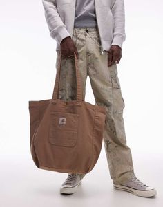 Accessories by Carhartt WIP Bagging compliments Branded design Twin handles Logo patch Front pocket Beige Tote, Trainer Heels, Leggings Sale, Wide Jeans, White Trainers, Carhartt Wip, Hoodies For Sale, Adidas Samba, Vans Old Skool