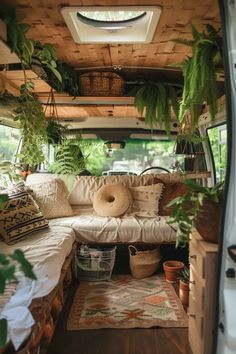 the inside of an rv with plants and pillows